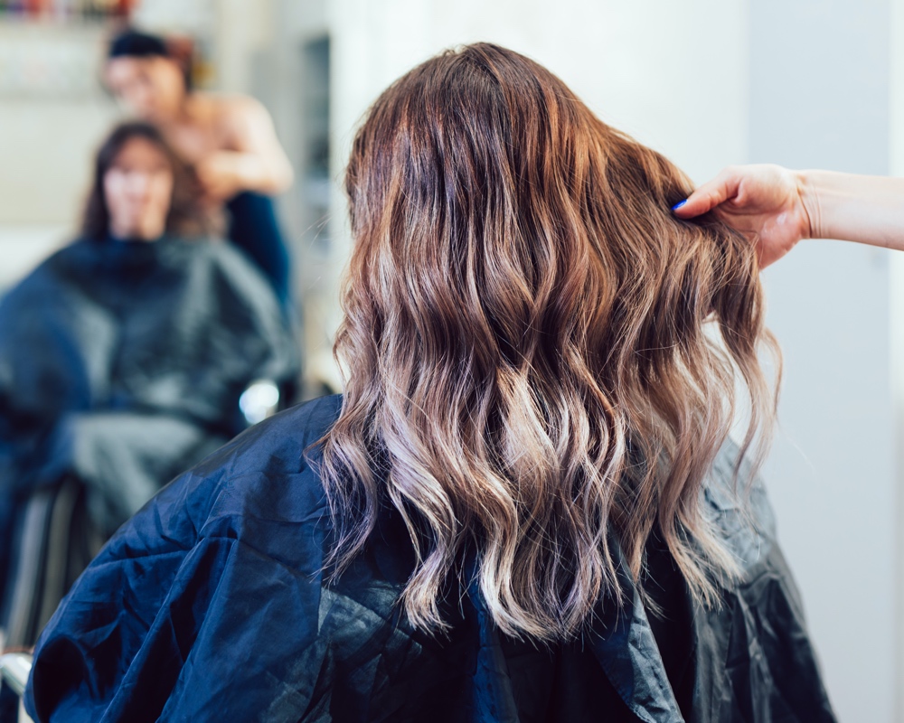 Woman holding lady's hair